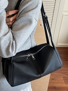 Chic black pebbled leather underarm bag for women with dual silver zippers in daily use