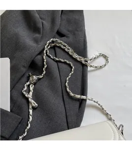 Close-up of white soft leather cloud bag with silver metal and leather chain strap detail