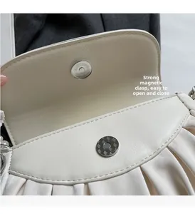 Close-up detail of the strong magnetic closure and soft wrinkled leather texture of the bag