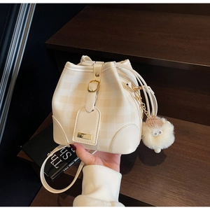 Creamy checkered bucket bag with drawstring closure and cute sheep pendant detail