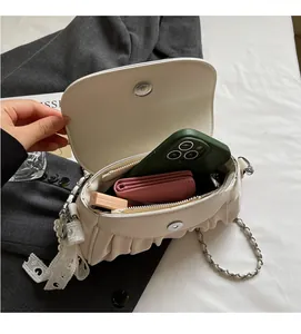 Interior view of cream white cloud bag showing capacity for phone, wallet and lipstick