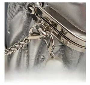 Detail view of silver quilted handbag with high-gloss metal hardware and pearl chain