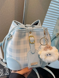 Light blue plaid bucket bag with drawstring closure and cute plush charm detail