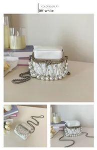 Detail of off-white quilted handbag with pearl handle and metal clasp closure