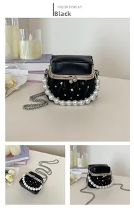 Detail of mini black pleated bag with pearl handle and rhinestone embellishments