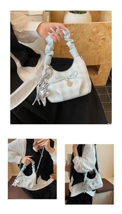 Detail of blue checkered handbag featuring heart plate, bow, and star pendant details