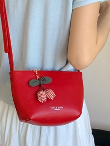 Fashionable red large bucket bag with cherry charm and white fashion lettering