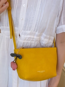 Chic yellow leather bucket bag for women with cherry charm and brand logo detail