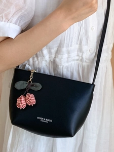 Minimalist black leather shoulder bag with tulip charm and KOSK & BAGS branding