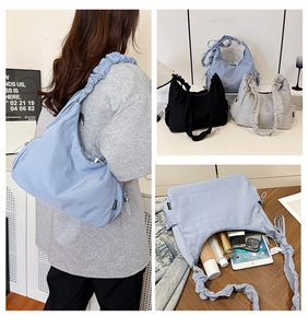 Detail view showing large capacity storage and adjustable pleated shoulder strap of the tote bag