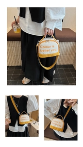 Detail view of contrast color canvas crossbody bag with adjustable strap for students