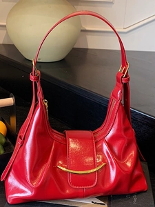 Stylish red glossy hobo bag with golden crescent buckle and adjustable shoulder strap