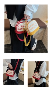 Detail showing two-tone canvas bags in red and yellow with large letter prints and straps