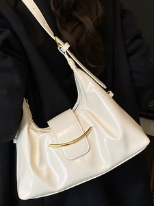 Chic cream white hobo underarm bag with gold metal buckle and glossy leather finish