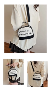 Macro shot of canvas mini crossbody bag with black trim and unique letter print design