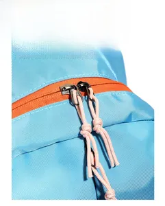 Close-up of sky blue backpack zippers with orange accents and pink pull cords
