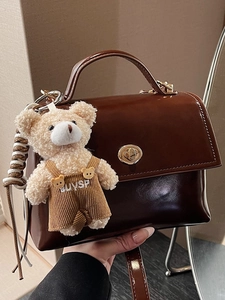 Trendy dark brown vintage crossbody bag with gold lock and cute teddy bear pendant