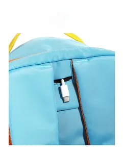 Detail view of the nylon backpack with integrated USB charging port and white Type-C cable