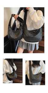 Detail view of black nylon crossbody bags in two sizes with adjustable straps and zipper