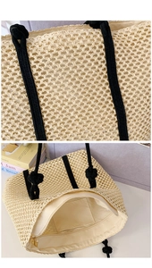Detail view of woven straw tote bag featuring black rope handles and inner zipper pocket