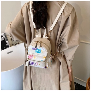 Close-up of beige PU leather mini backpack featuring colorful cat graffiti and gold hardware