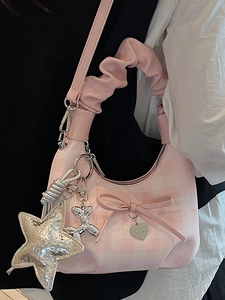 Pink checkered crossbody bag for women with decorative metallic charms and ruffled handle