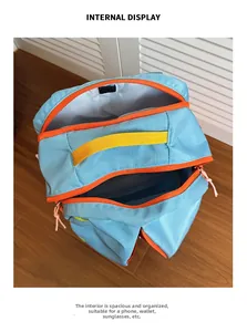 Internal display of multi-compartment light blue nylon backpack with orange zippers