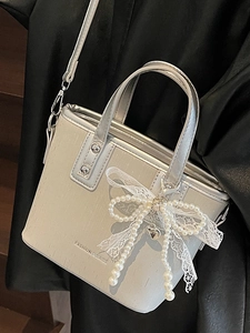 Silver textured bucket bag with pearl bow charm and Fashion & Bags print
