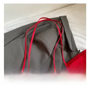 Detail showing red canvas tote bag with thin lightweight shoulder straps and textured fabric