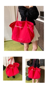 Close-up of red canvas tote bag featuring white San Francisco eco-friendly printing