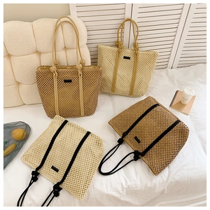 Detailed view of woven mesh tote bags in beige and khaki with knotted rope handles