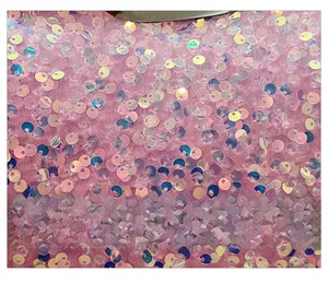 Close-up of pink holographic sequins fabric on a fashion shell clutch evening bag