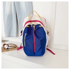 Outdoor backpack detail showing vibrant blue and beige contrast with yellow branding