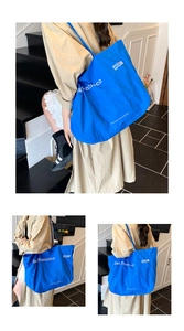 Detailed view of blue San Francisco tote bag with recyclable upcycling branding text