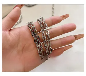 Close-up of polished silver metal chain strap with oval links for a shoulder bag