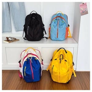 Detailed display of multi-color outdoor backpacks in black, blue, white, and yellow