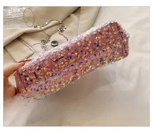 Detail view of the bottom structure of pink sequin chain bag with silver metallic strap
