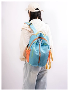 Detail of waterproof nylon crossbody bag with orange mesh pocket and zipper compartments