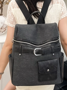 Minimalist dark gray canvas backpack with black leather accents for daily commute