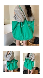 Detail of vibrant green canvas tote bag with San Francisco print and eco-friendly text