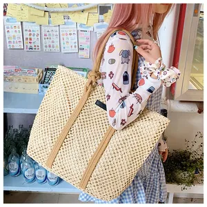 Detail showing the intricate openwork crochet texture of the beige woven summer tote bag