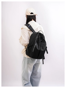 Detail showing durable black nylon ripstop fabric and adjustable straps of the outdoor backpack