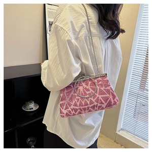 Pochette da sera rosa con ricamo di paillettes e manico tondo argento indossata