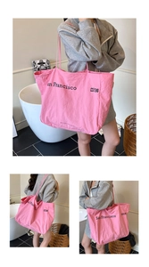 Detailed macro view of the bright pink foldable tote bag featuring San Francisco lettering