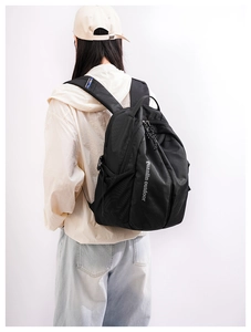 Detail of black nylon backpack with Guanlin Outdoor logo and adjustable mesh straps