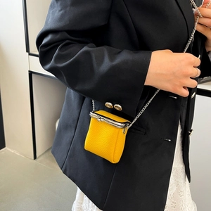 Mini yellow lychee leather lipstick bag with silver chain strap and metal clasp detail