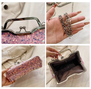 Detail view of pink sequin clutch featuring pearl clasp and silver chain strap