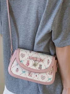 Sweet pink ballet crossbody bag with ribbon and rabbit pattern on model shoulder