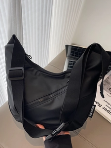 Minimalist black nylon crescent crossbody bag with adjustable wide strap for daily sports