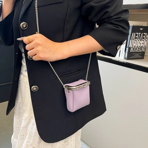 Detail of lavender litchi grain leather mini lipstick bag with silver chain and clasp